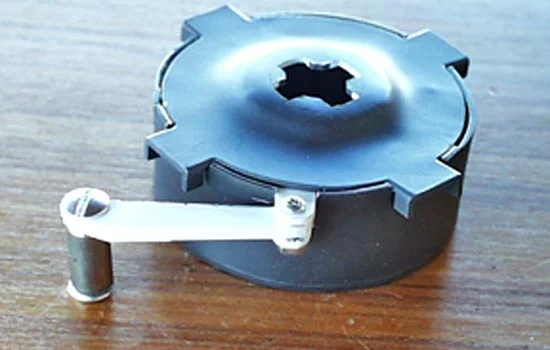 The roller arm attaches the spring case that sits in the middle of the track.