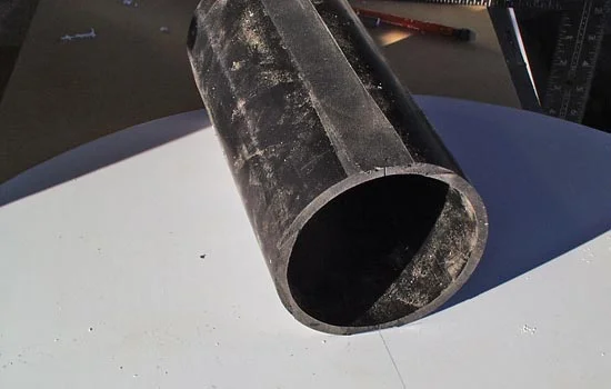 I cut a section of pipe to be embedded in the head. I flattened two sides to glue to the front and back.