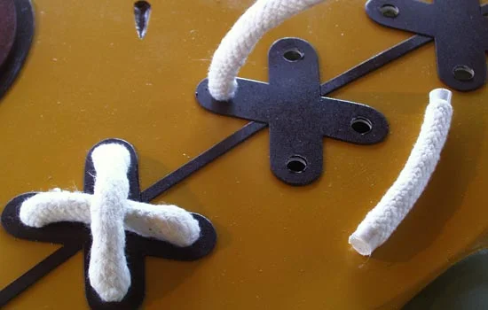 I used 1/2″ thick upholstery edging for the stitches. To keep them from unraveling, I taped the edges and applied hot glue to the ends. The ends were then tucked into 3/8″ hole.