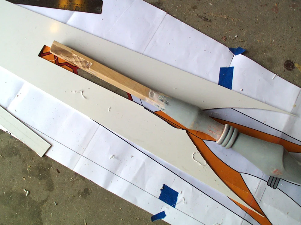 I cut the profile of the head from a thick sheet of styrene and cut a channel for the shaft to fit into.
