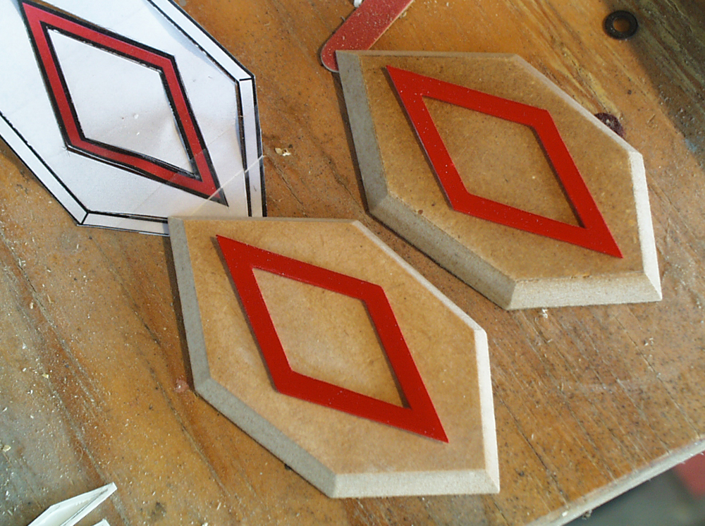  I cut the recess polygons from 1/4″ MDF and used styrene to make the diamond details. 