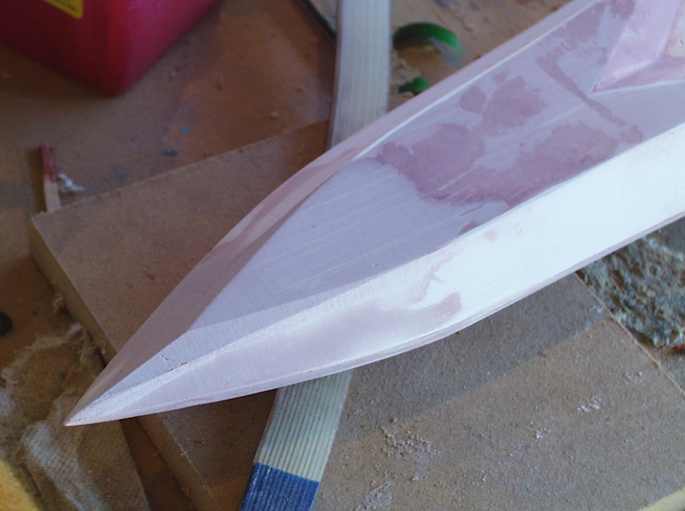  After looking at the reference material, I discovered that the tip need a knife edge rather than the point I had. I added Bondo to build up some thickness and then sanded a proper knife edge. 