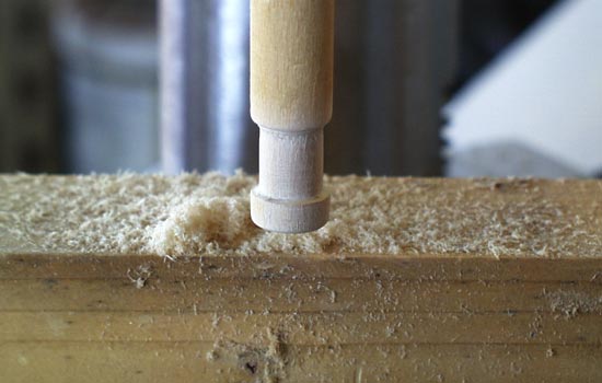  I chucked 1/2″ dowels into the drill press to make a “poor man’s lathe”. I shaped the pegs with files and sandpaper. 