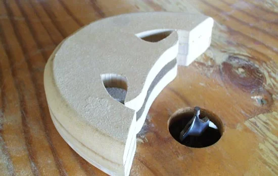 I glued three pieces of MDF to form the guard, leaving a channel for the blade. It was rounded on the router table.