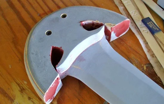 I glued the guard on to the blade and puttied up the seams. I also inserted screws to give the guard extra strength.