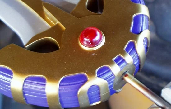 I cast some resin gems and glued them to both sides of the guard.