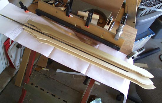 I started with a 5/16″ steel rod for a core. I cut a channel through a 1/4″ thick plank of poplar to contain it.