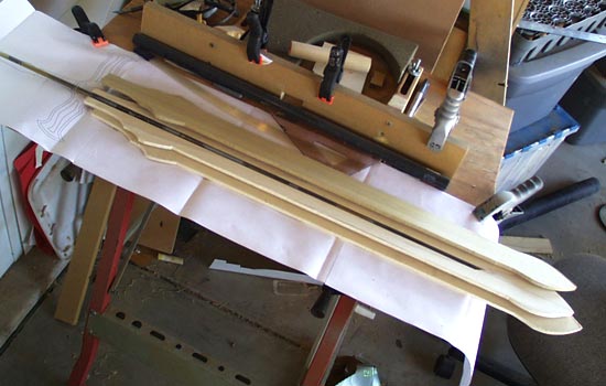  I started with a 5/16″ steel rod for a core. I cut a channel through a 1/4″ thick plank of poplar to contain it. 