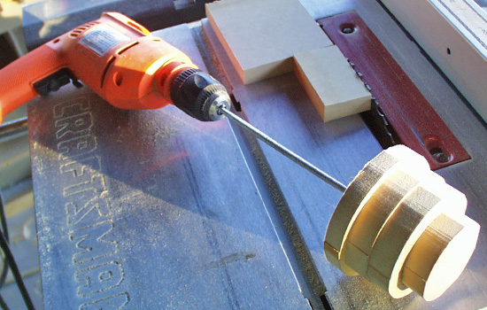 I stacked MDF and sanded it to shaped on a “poor man’s lathe” to make the dome.
