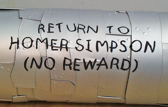  …and his “Return” message on the back. 