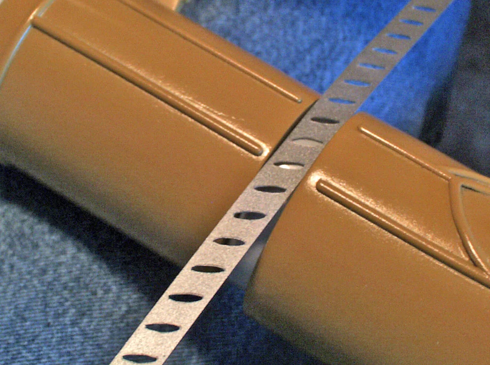 The vents holes were cut from a thin sheet of styrene. It was glued over reflector tape….