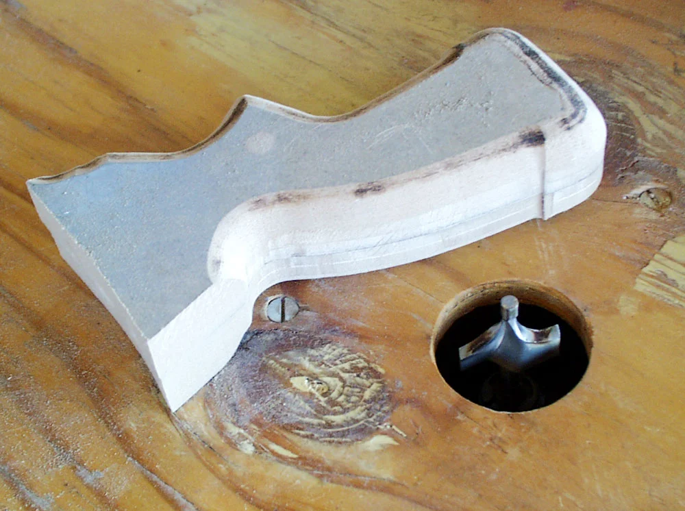 I temporarily glued the grip halves together for shaping. I started by rounding the edges with a router.