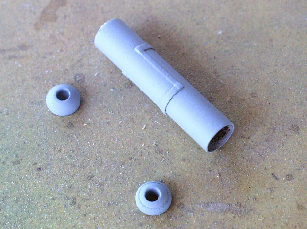 The rear sight was made by drilling a hole in acrylic cabochons (domes) and gluing them to the ends of a brass rod.