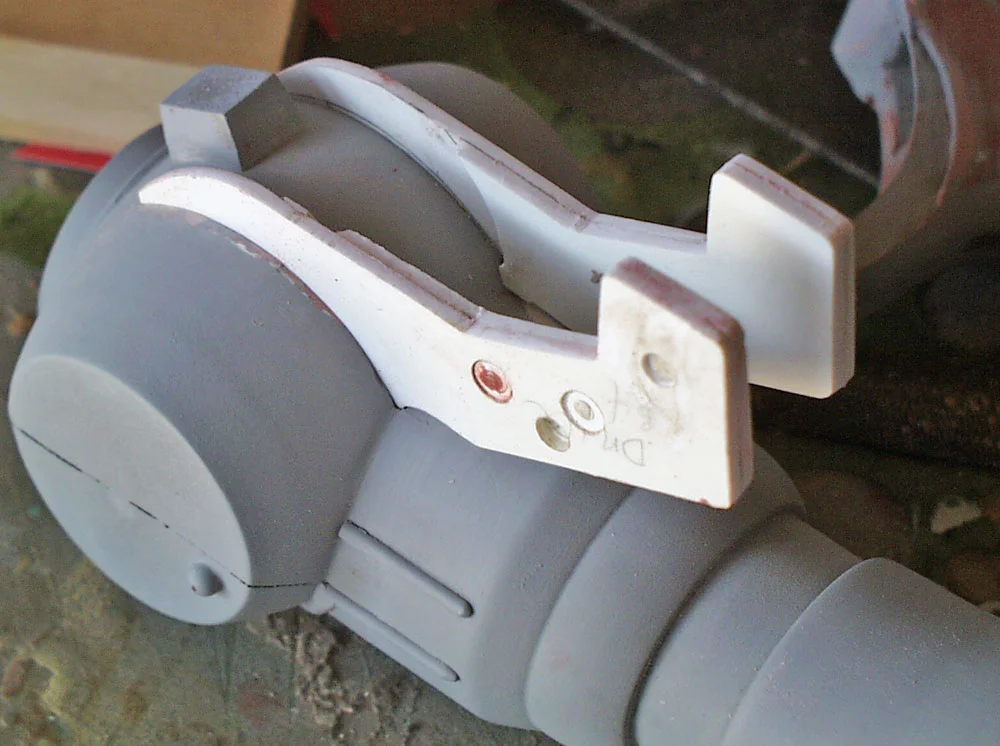 I had to cut away part of the grip to make room for the trigger guards. It looks sloppy here but I was able to clean up the seam with putty.