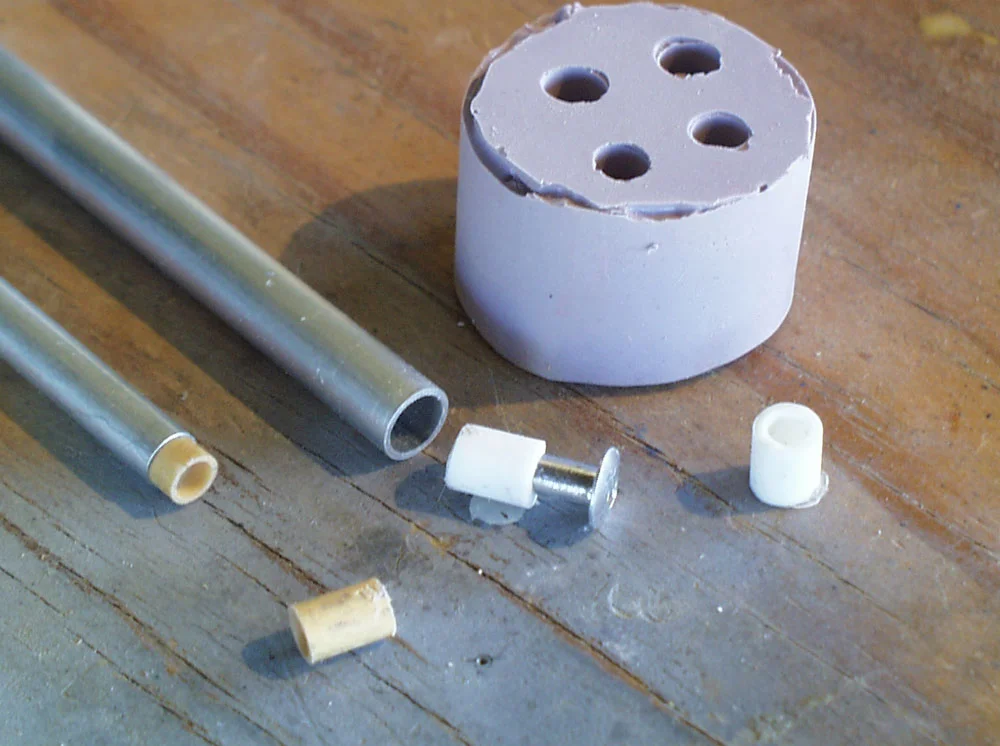 I wanted to use aluminum tubing for the trigger guard connector and the breach arm bar. Unfortunately the rivets are much smaller than the inner diameter of the tubes. I made and cast resin adapters to make them fit.