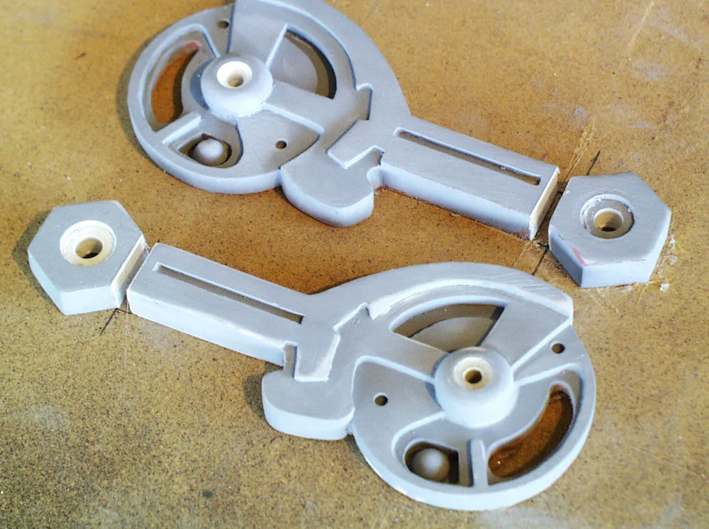 During a test fit, I discovered that I didn’t make the breach arms long enough for the bar to clear the edge of the cap. I took resin arms and cut off the ends. The gap was filled with Bondo, sanded smooth and then I made a new mold for the arms.