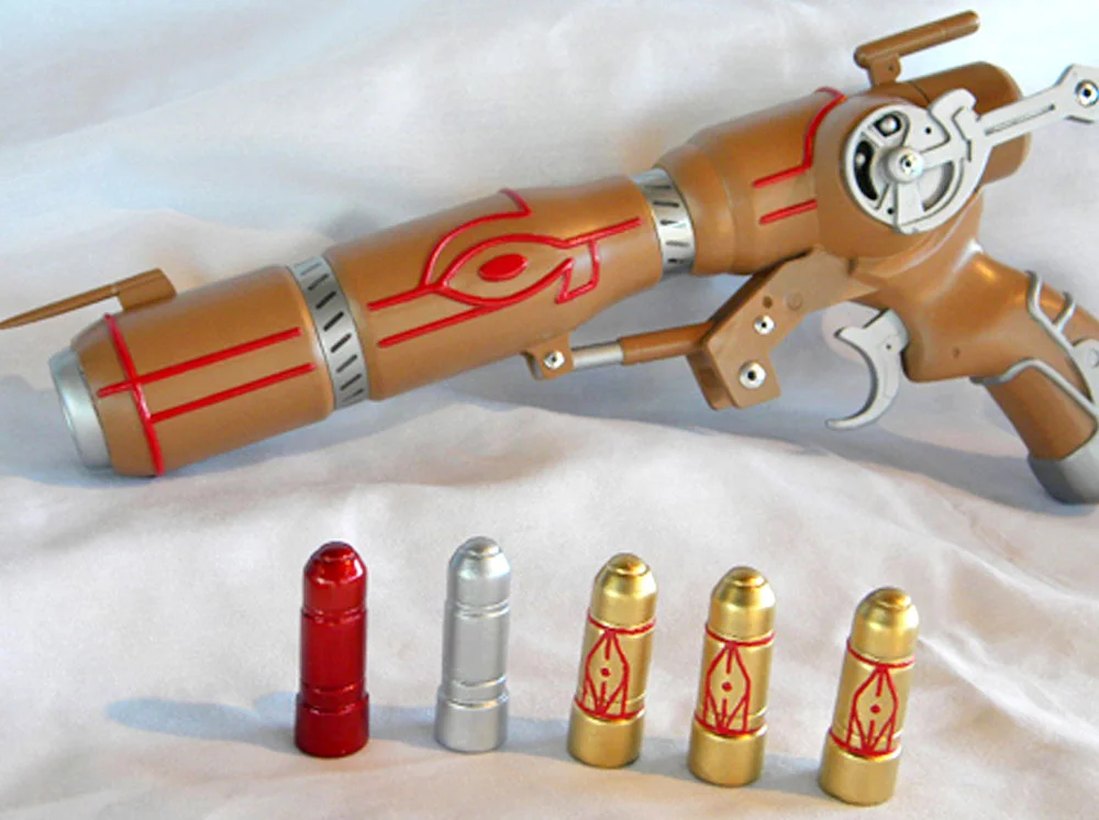 The final pained gun. After testing over a dozen different paints, I found the perfect Caster Gun brown! It has golden tints (that I mistook for gold on my original Caster) but is light enough to contrast nicely with the red piping.