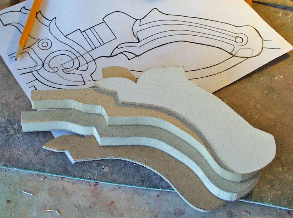 The grip was cut from 1/2″ MDF with 1/8 MDF grip plates. In order to later insert the trigger and other parts, I needed to be able to split it in half.