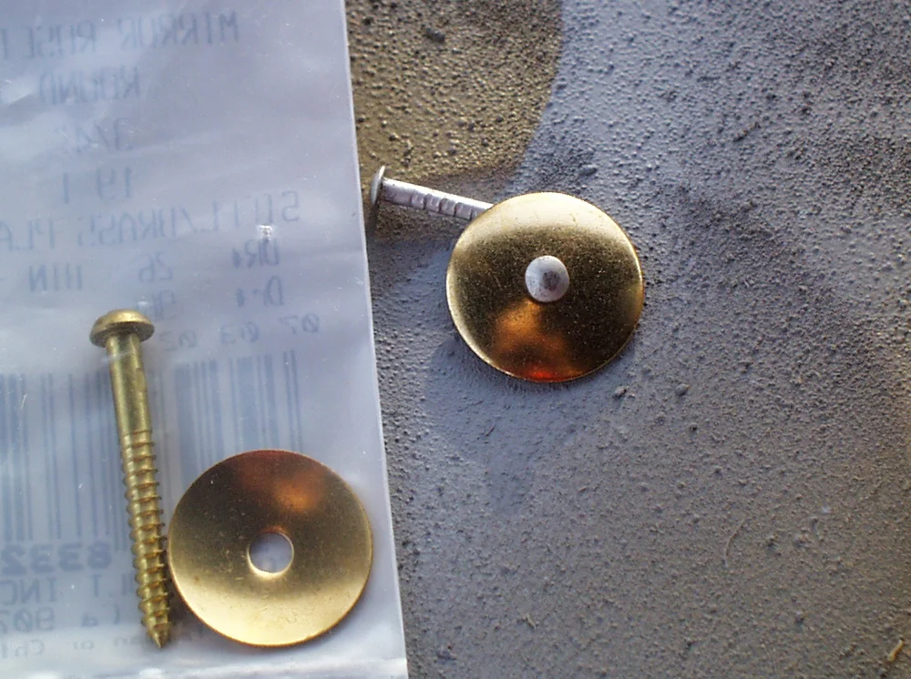 I picked up some mirror rosettes to use as a round element on the basket. I substituted an nail for the center screw.