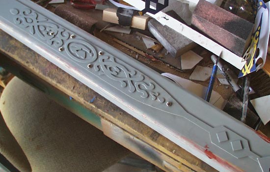  I wanted to make the design on the scabbard with more relief so I made a master from thicker styrene and used scrapbooking brads for the rivets 