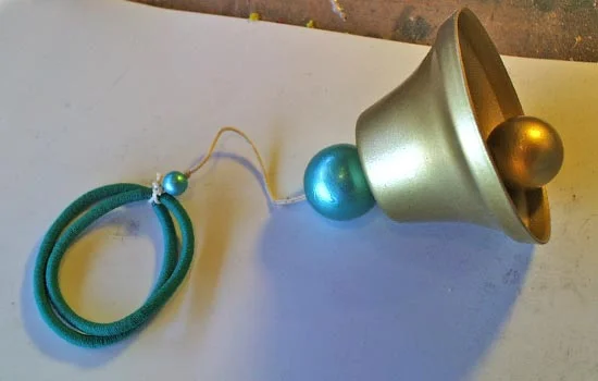The bell assembly was attached to two elastic hair ties.