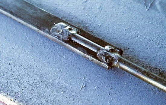 I had a friend weld a 5/16″ steel rod to a 3-16″ x 3/4″” steel bar. I planned to make half the blade and guard cast cast copies to glue together around the steel.