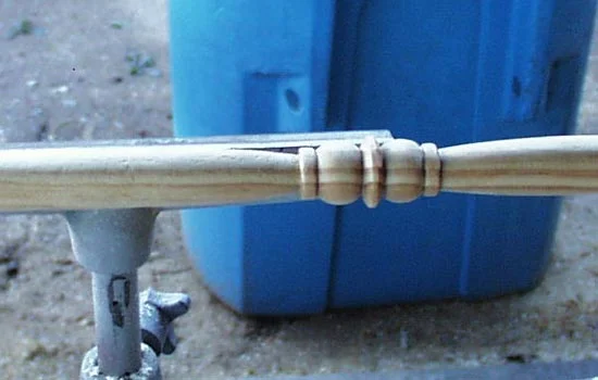 The grip was lathed out of pine stock. I then sealed it with gloss black paint.