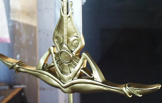 I masked off the silver and painted the hilt with a Krylon gold leaf paint. The sword was then coated with a protective top coat of Future.