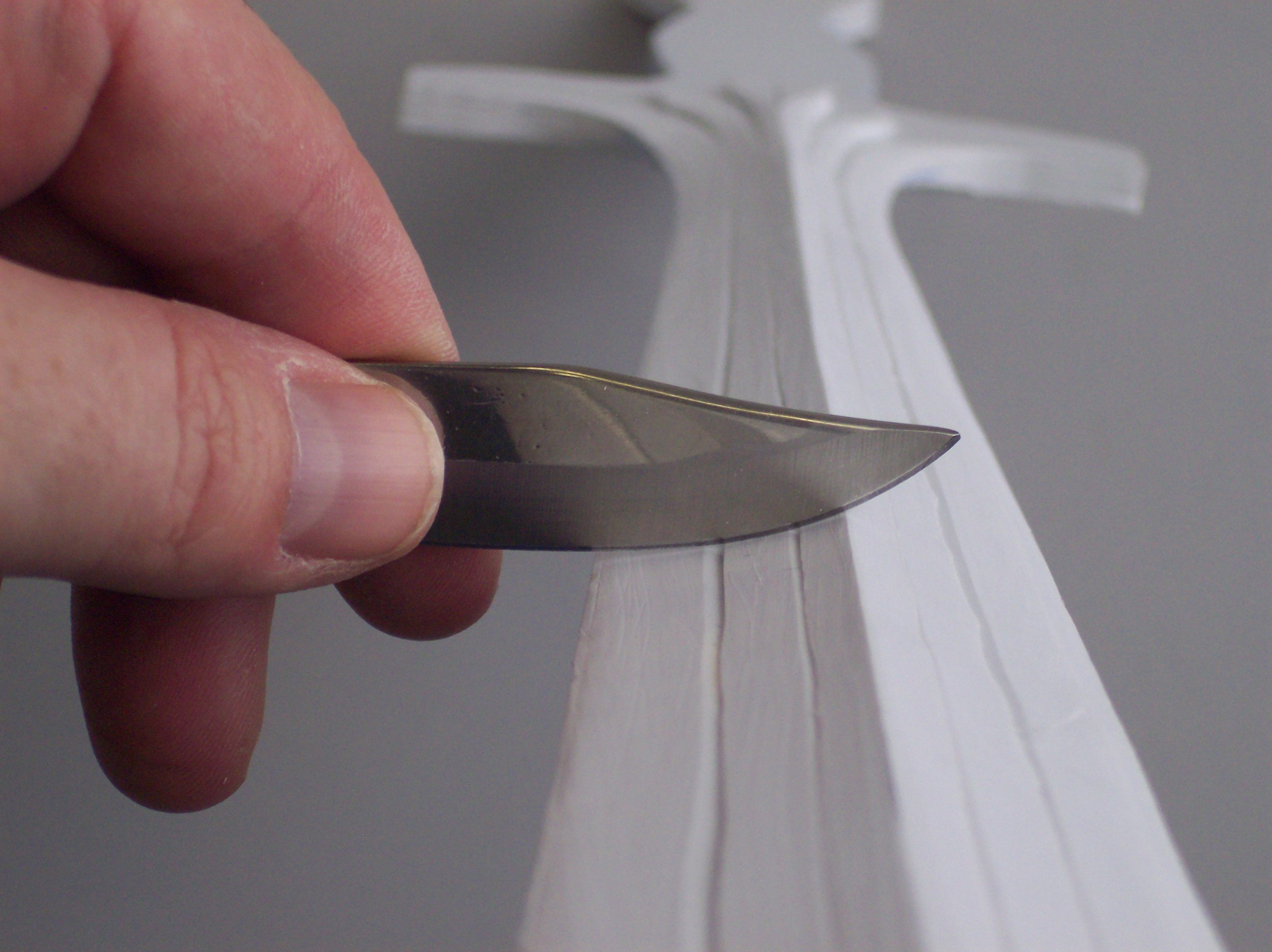  I used the long blade from my Swiss Army knife to shave a blade edge on the sword. Hold the knife’s edge PERPENDICULAR to the surface of the plastic and you can shave the plastic into shape. This also works as a alternative to rough sanding. 