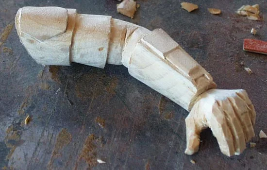 The left arm carved from one of the scraps. It was difficult to find a piece with the grain running in the right direction. If it ran perpendicular to the arm, it would be weak.