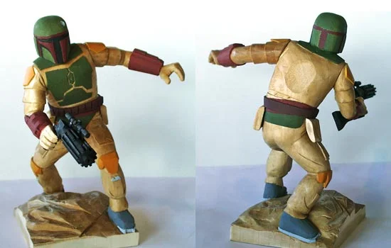 I coated the entire figure in shellac which seals the wood and brings out the grain. Since the wood looked so good, I decided to only paint parts that were NOT representing fabric (or the ground). I sanded a flat spot on the back to allow easy attaching of the rocketpack.