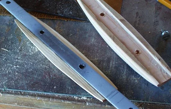 I used pine scraps to form the handle. I screwed one half to the steel.