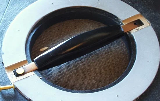 The handle was secured with brass screw posts that went through the entire shield.