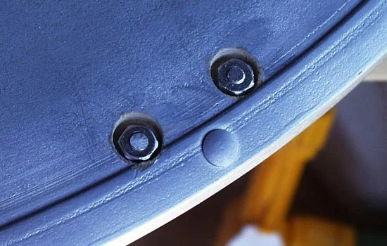 The threaded ends were inserted through the shield, cut flush and then bolted.