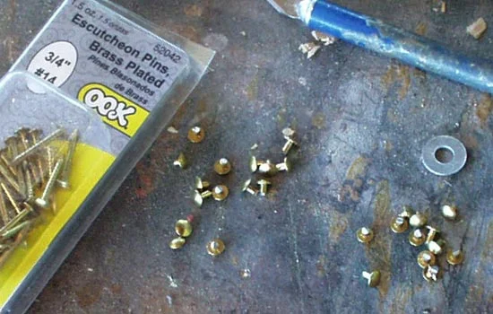 Each of the rim “triangles” have three brass rivets. I used brass plated nails and trimmed off the heads to use as the rivets. I drilled a shallow hole and then epoxied them in.