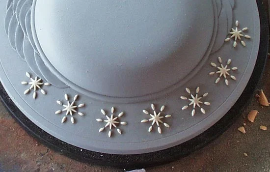 I carved one star using the same method and then molded it in silicone. I cast copies of it in resin and then glued the pieces to the MDF.