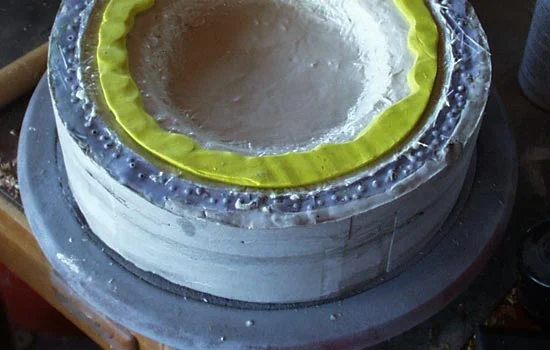 I needed to build an edge so the boss could be attached to the shield. I built up a barrier with clay and then poured resin into the edge.