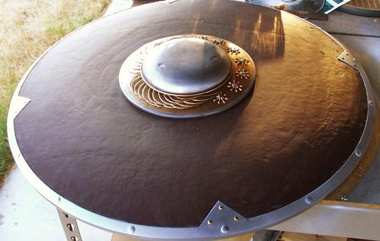 I re-painted the rim and added the brass rivets to each outside triangle. The boss was then epoxied to the center of the shield.