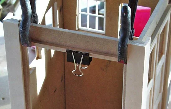 1/4″ MDF was used for the area over the doorway with beveled strips to frame the doors.