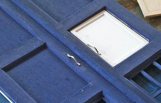 I used pliers, tin snips and files to shape the staples into the handles for both the phone door and main door. They were CA glued in place.