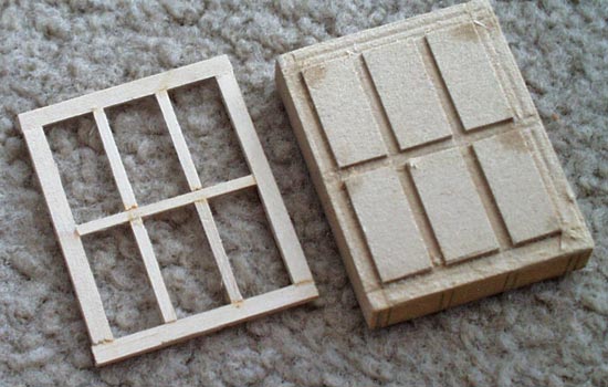  The window frames were cut from strips of 1/16″ basswood. I made a jig out of MDF so they would all turn out the same. 
