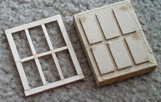 The window frames were cut from strips of 1/16″ basswood. I made a jig out of MDF so they would all turn out the same.