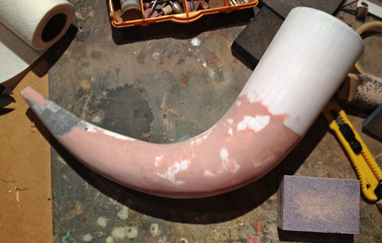  Once the entire horn was cast, I smoothed out the folds by sanding and adding Bondo. 