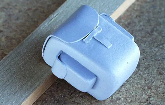 Later in the episode Abe is wearing a backpack. I cut a piece of MDF to shape for the main section and side pockets. The straps were cut from .02 styrene (after MUCH prototyping).