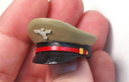  The final painted hat. Added are a styrene eagle and gold tabs at the ends of the band. The button on the ends of the band were made with a dot of CA glue. 