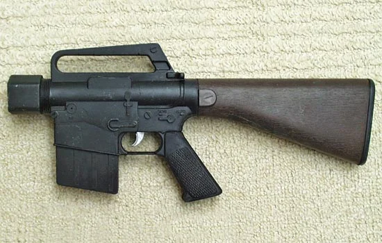 This gun was built for a contest run every year by the Blaster Builder’s Club. The rules state that you must create a blaster of your own design using a toy gun as a base. I started with a partial M-16 that I had sitting in my scrap plastic box for 20 years.