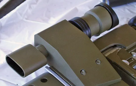 The final scope attached to the rifle with exposed hex screws.