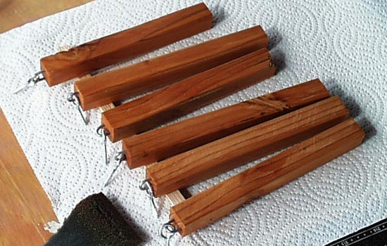 The arms were cut from pine, using staples and eye screws to attach them to the body.