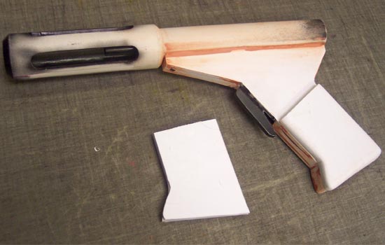 I then airbrushed the interior of the muzzle. For final painting with spray paint, I didn’t want to miss or overpaint any of these confined areas. The receiver tube was epoxied to the grip and puttied to hide the seam. I cut out the grip plates from sheet styrene and sanded them to shape.
