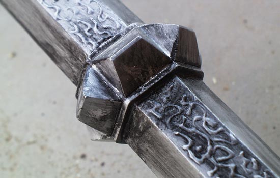 I added the “Black Tongue” runes to alternating facets of the shaft with craft “puffy paint”.